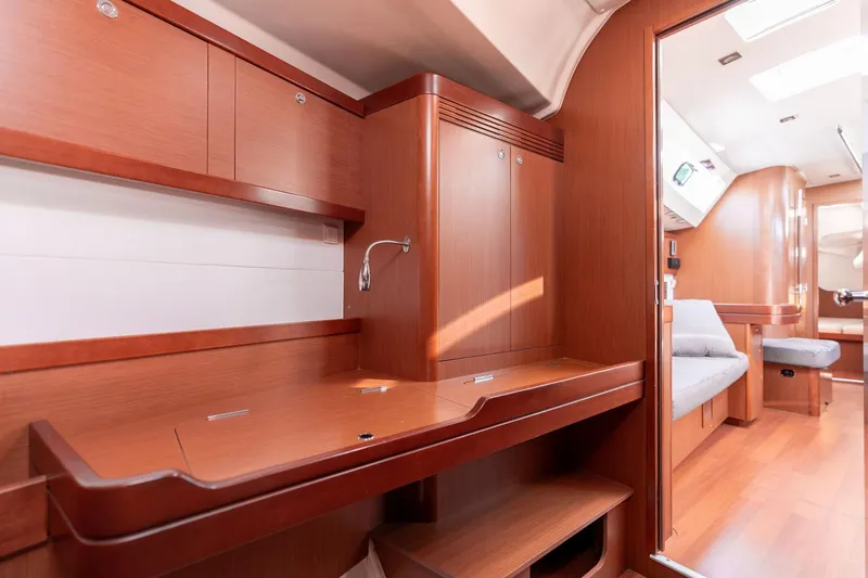 Slide: The Image of 2013 Beneteau Oceanis 50 interior with wooden cabinetry and seating area. - 20