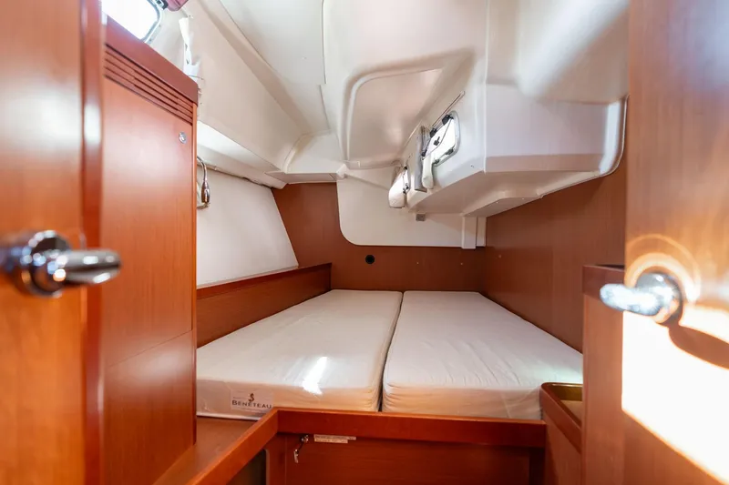 Slide: The Image of 2013 Beneteau Oceanis 50 cabin interior with wooden finish and twin beds. - 23
