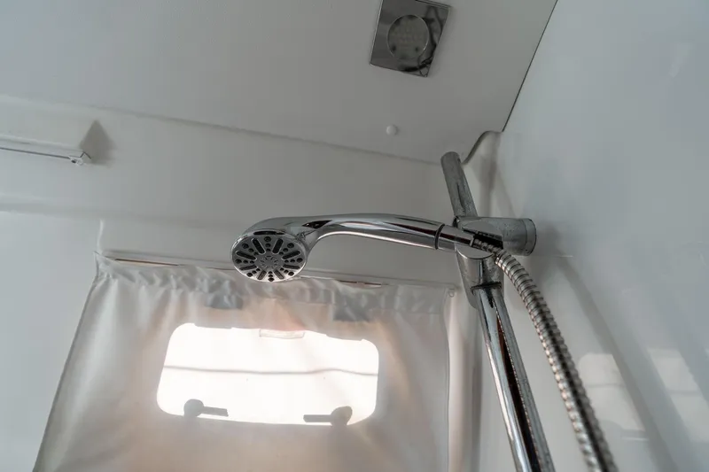 Slide: The Image of Shower area in 2013 Beneteau Oceanis 50 yacht, featuring chrome fixtures and a window. - 27