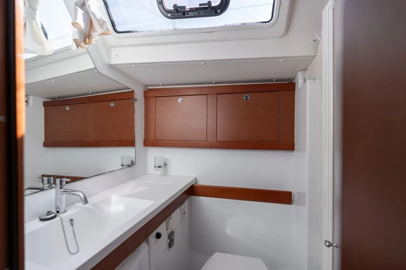 Slide: The Image of Interior of 2013 Beneteau Oceanis 50 yacht bathroom with wooden cabinets and modern fixtures. - 28
