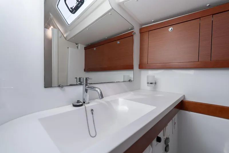 Slide: The Image of Modern bathroom interior of 2013 Beneteau Oceanis 50 yacht with sleek sink and wooden cabinets. - 29