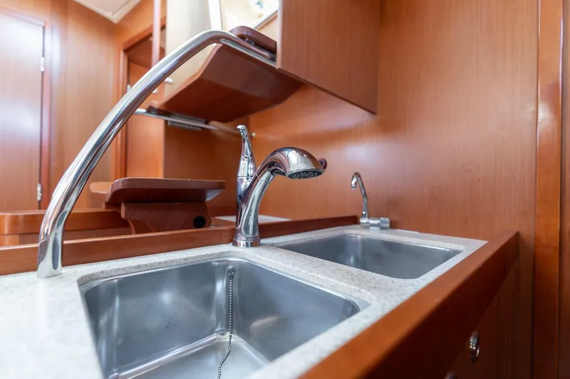 Slide: The Image of Galley sink in 2013 Beneteau Oceanis 50 yacht with wooden cabinetry. - 35