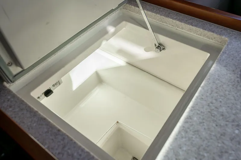 Slide: The Image of Beneteau Oceanis 50 (2013) yacht interior storage compartment, open lid view. - 37