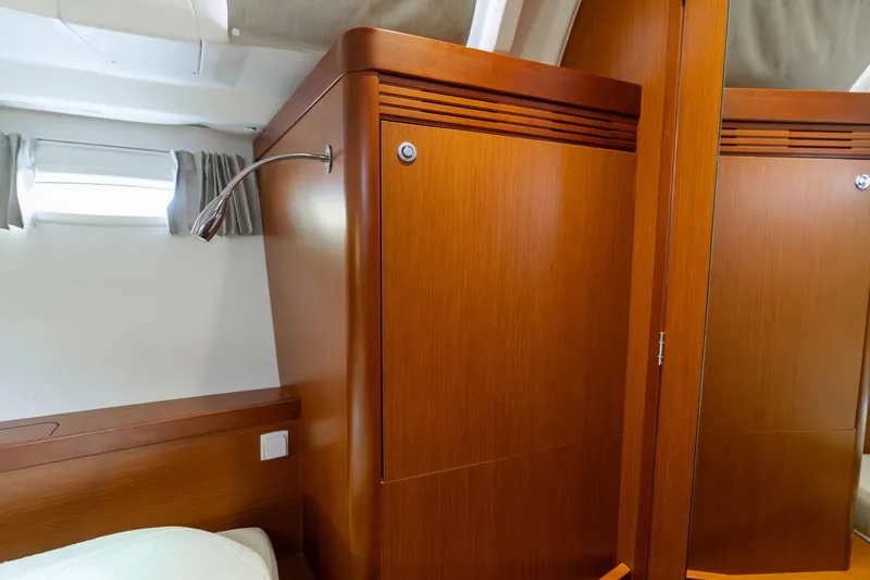 Slide: The Image of Interior cabin of 2013 Beneteau Oceanis 50 yacht with wooden finish and reading light. - 40