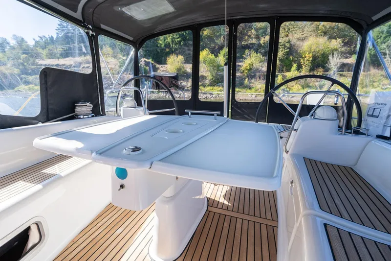 Slide: The Image of 2013 Beneteau Oceanis 50 cockpit with dual steering wheels and teak flooring. - 42