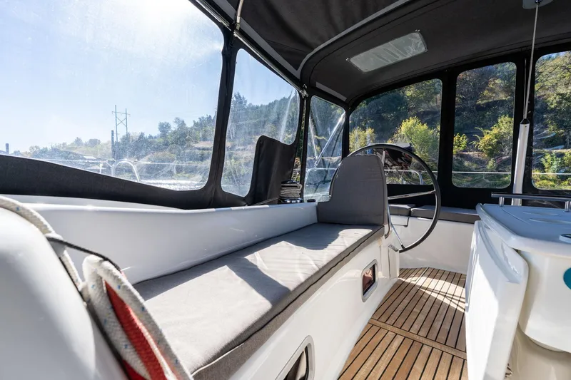 Slide: The Image of Interior view of 2013 Beneteau Oceanis 50 sailboat cockpit with seating and steering wheel. - 43