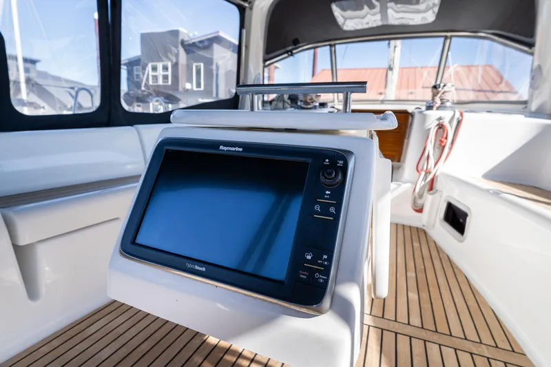 Slide: The Image of Beneteau Oceanis 50 cockpit with Raymarine display, teak flooring, and modern design, 2013 model. - 44