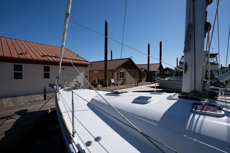 Slide: The Image of 2013 Beneteau Oceanis 50 sailboat docked at marina under clear blue sky. - 59