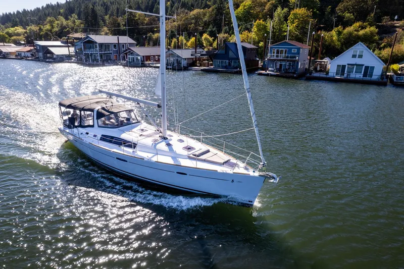 Slide: The Image of 2013 Beneteau Oceanis 50 sailing on a scenic river near waterfront homes. - 67