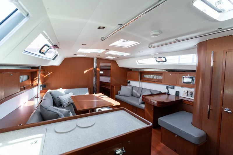 Slide: The Image of Interior of 2013 Beneteau Oceanis 50 yacht, featuring modern wood finish and spacious seating. - 7