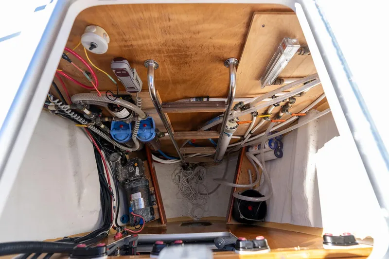 Slide: The Image of Engine compartment of 2013 Beneteau Oceanis 50 sailboat, showcasing wiring and mechanical components. - 76