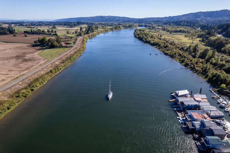 Slide: The Image of Aerial view of 2013 Beneteau Oceanis 50 sailing on a scenic river. - 83