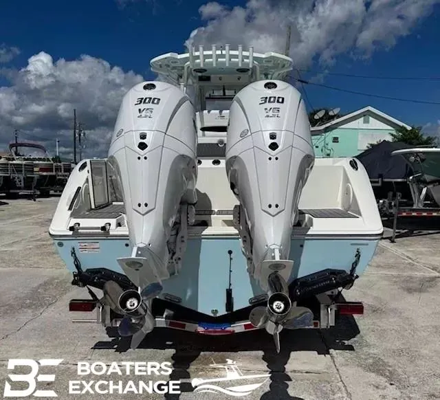Slide: The Image of 2026 Cobia 305 Center Console with twin outboard engines. - 2