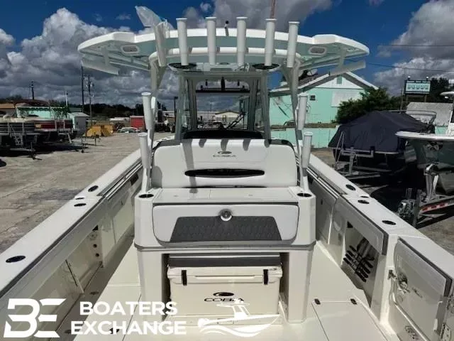 Slide: The Image of Cobia 305 Center Console boat, 2026 model, parked outdoors. - 3