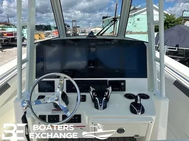 Slide: The Image of Cobia 305 Center Console 2026 helm with modern electronics. - 7