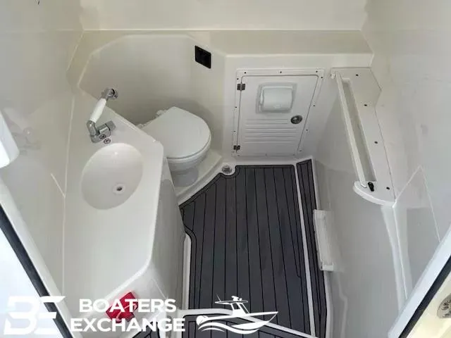 Slide: The Image of Interior of 2026 Cobia 305 Center Console with toilet and sink. - 8