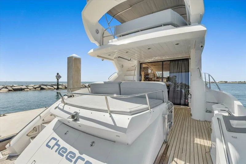 Slide: The Image of Sunseeker Manhattan 52 yacht, 2009 model, docked with spacious deck and ocean view. - 12
