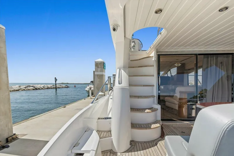 Slide: The Image of 2009 Sunseeker Manhattan 52 yacht interior with staircase, docked by the sea. - 15
