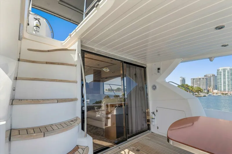 Slide: The Image of Luxurious 2009 Sunseeker Manhattan 52 yacht interior with staircase and waterfront view. - 19