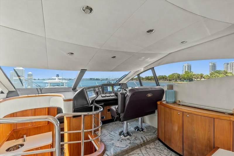 Slide: The Image of 2009 Sunseeker Manhattan 52 yacht helm with modern controls and waterfront view. - 26