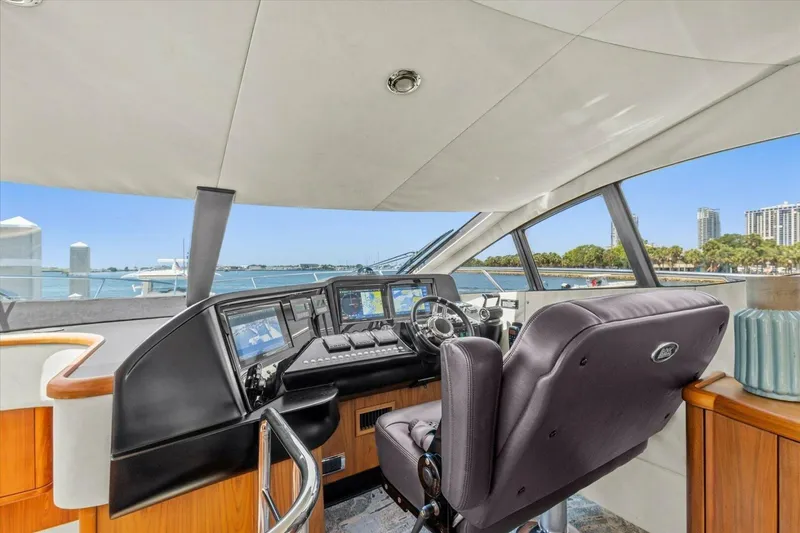 Slide: The Image of Luxurious 2009 Sunseeker Manhattan 52 yacht cockpit with advanced navigation systems and waterfront view. - 27