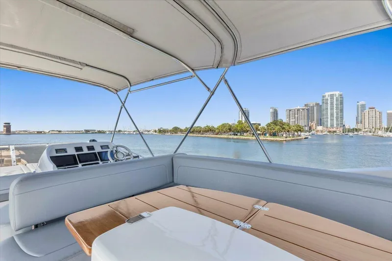 Slide: The Image of Flybridge view from 2009 Sunseeker Manhattan 52 yacht, overlooking waterfront cityscape. - 49