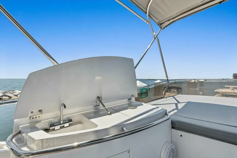 Slide: The Image of 2009 Sunseeker Manhattan 52 yacht deck with ocean view and palm trees. - 53