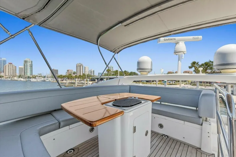 Slide: The Image of 2009 Sunseeker Manhattan 52 yacht deck with seating and table, overlooking marina. - 55