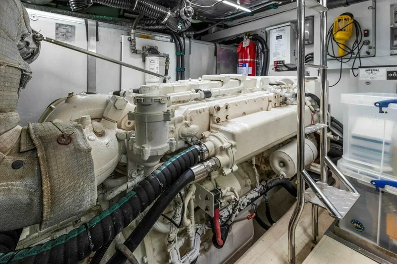 Slide: The Image of 2009 Sunseeker Manhattan 52 yacht cruising on open water under clear blue sky. - 58