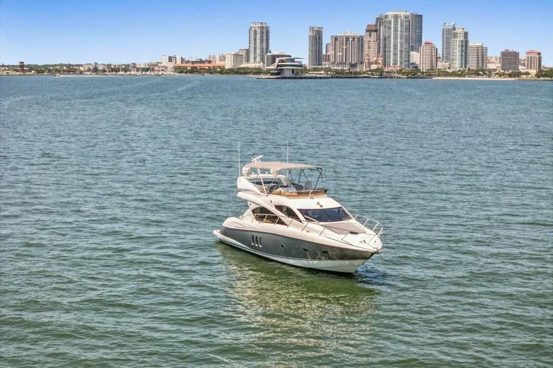 Slide: The Image of 2009 Sunseeker Manhattan 52 yacht cruising on open water under clear blue skies. - 63