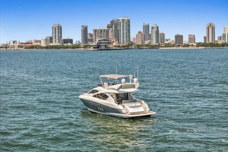 Slide: The Image of 2009 Sunseeker Manhattan 52 yacht cruising near city skyline. - 7