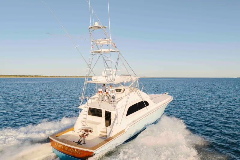 Slide: The Image of 1999 Bertram 60 Convertible yacht cruising on open water. - 17