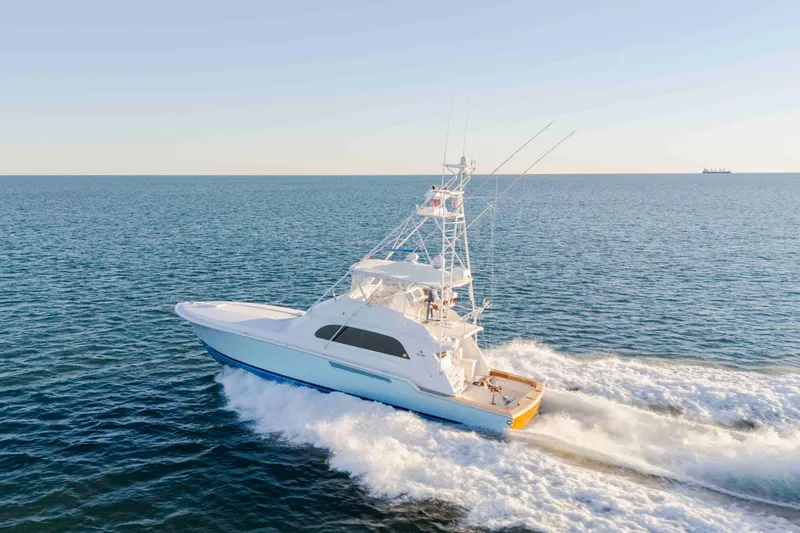 Slide: The Image of 1999 Bertram 60 Convertible yacht cruising on open sea. - 21