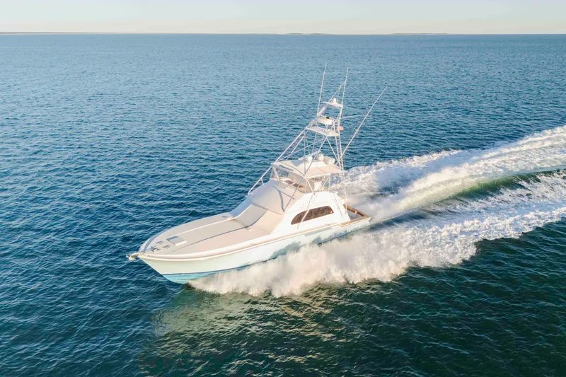 Slide: The Image of 1999 Bertram 60 Convertible yacht cruising on open sea. - 25