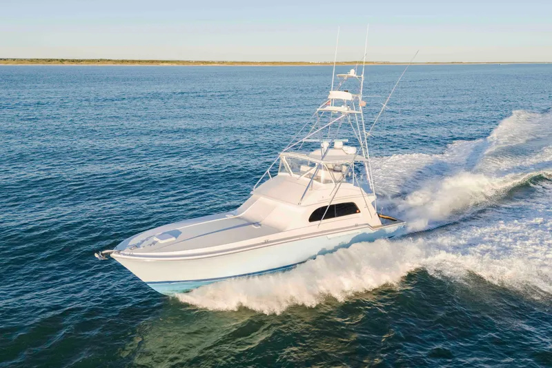 Slide: The Image of 1999 Bertram 60 Convertible yacht cruising on open water. - 27