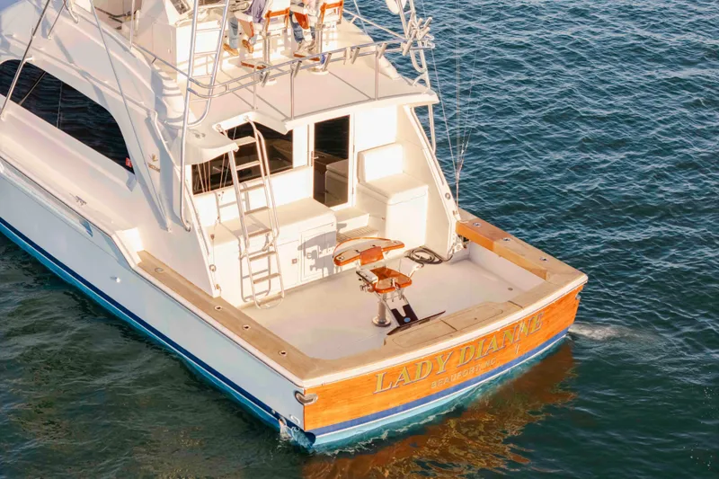 Slide: The Image of 1999 Bertram 60 Convertible yacht on water, rear view, named "Lady Dianne." - 3