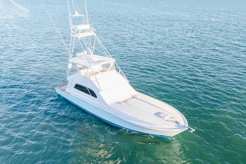 Slide: The Image of 1999 Bertram 60 Convertible yacht cruising on open water. - 31