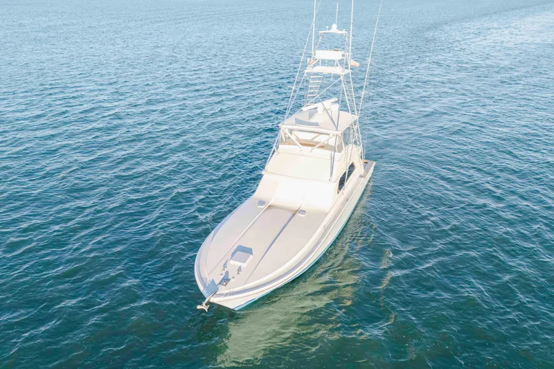 Slide: The Image of 1999 Bertram 60 Convertible yacht cruising on open water. - 32