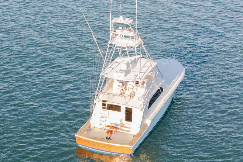 Slide: The Image of 1999 Bertram 60 Convertible yacht on open water, rear view. - 4