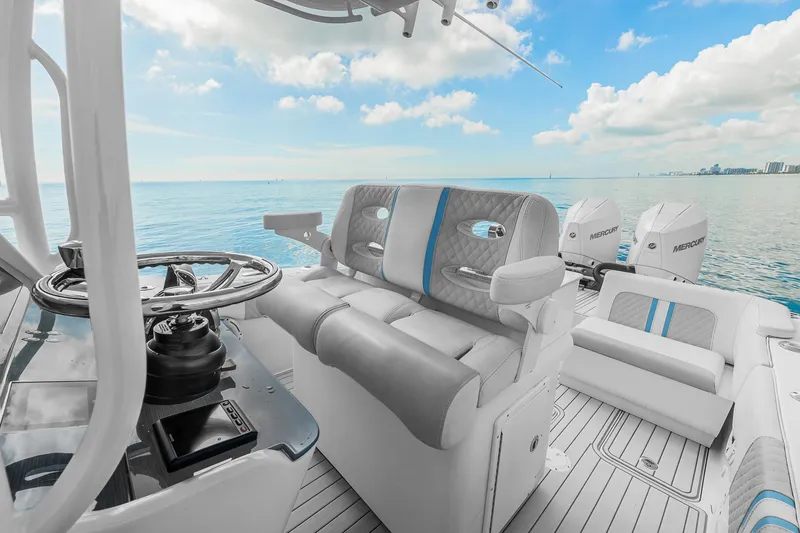Slide: The Image of 2023 Powerplay Powerboats 30 interior with luxurious seating and ocean view. - 10