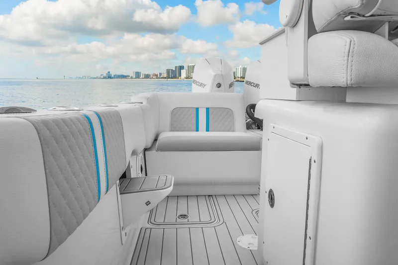 Slide: The Image of 2023 Powerplay Powerboats 30 interior with modern seating, ocean view, and city skyline. - 11