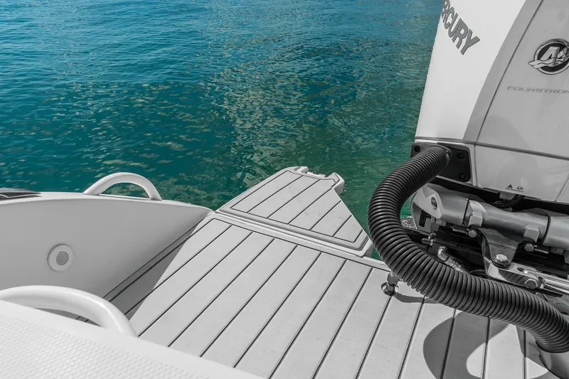 Slide: The Image of 2023 Powerplay Powerboats 30 with Mercury engine, docked on clear blue water. - 6