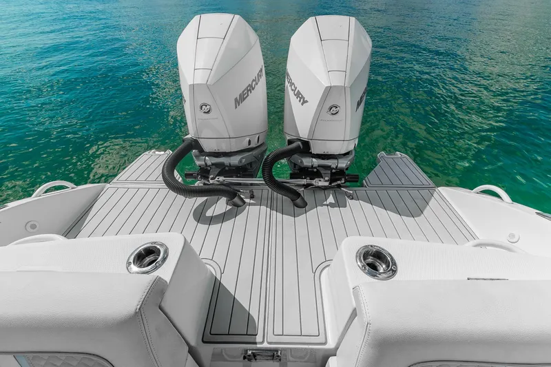 Slide: The Image of 2023 Powerplay Powerboats 30 with dual Mercury outboard engines on turquoise water. - 7