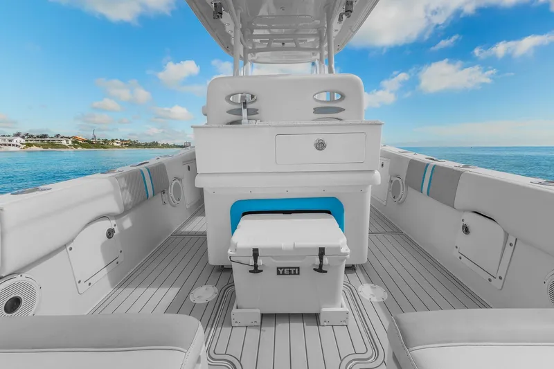 Slide: The Image of 2023 Powerplay Powerboats 30 interior with Yeti cooler, ocean view, and blue sky. - 8