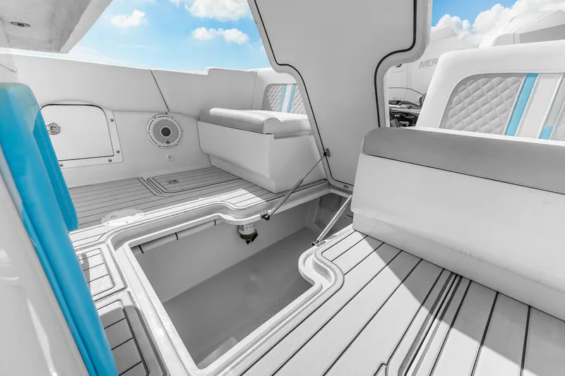 Slide: The Image of 2023 Powerplay Powerboats 30 interior with storage compartment and cushioned seating. - 9