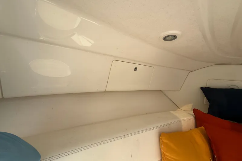 Slide: The Image of Interior of 2013 Intrepid 327 Cuddy with colorful cushions and storage compartment. - 17