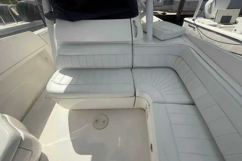 Slide: The Image of 2013 Intrepid 327 Cuddy boat interior with white cushioned seating. - 20