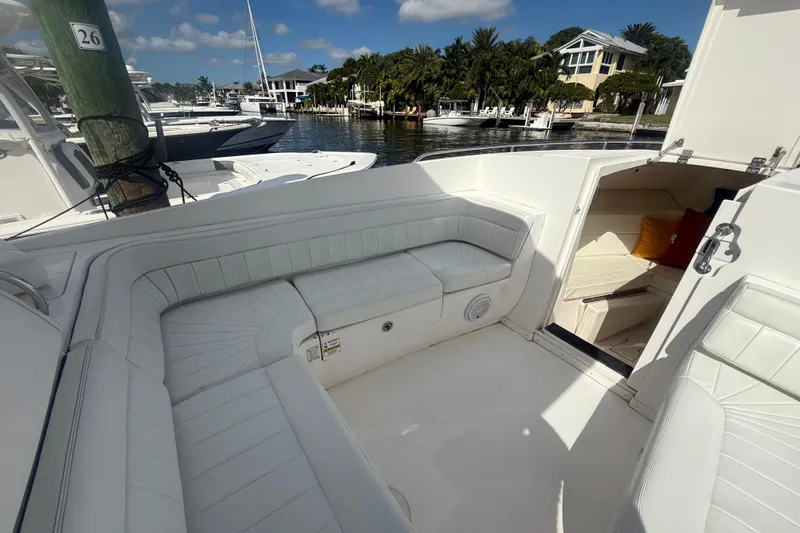 Slide: The Image of 2013 Intrepid 327 Cuddy boat interior with white seating and open cabin view. - 21