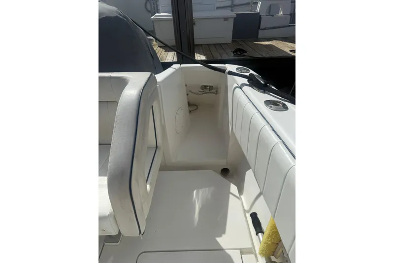 Slide: The Image of 2013 Intrepid 327 Cuddy boat interior with white seating and deck details. - 24