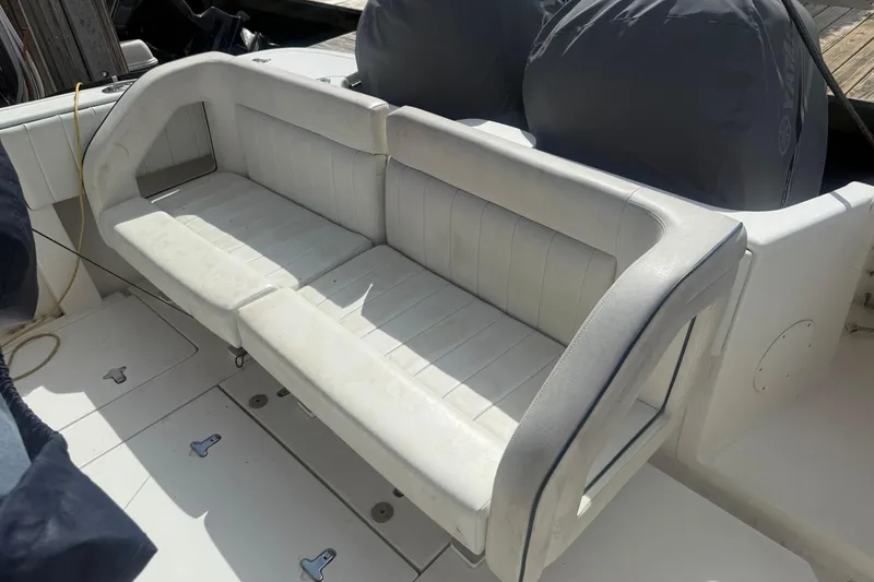Slide: The Image of White cushioned seating on a 2013 Intrepid 327 Cuddy boat deck. - 25